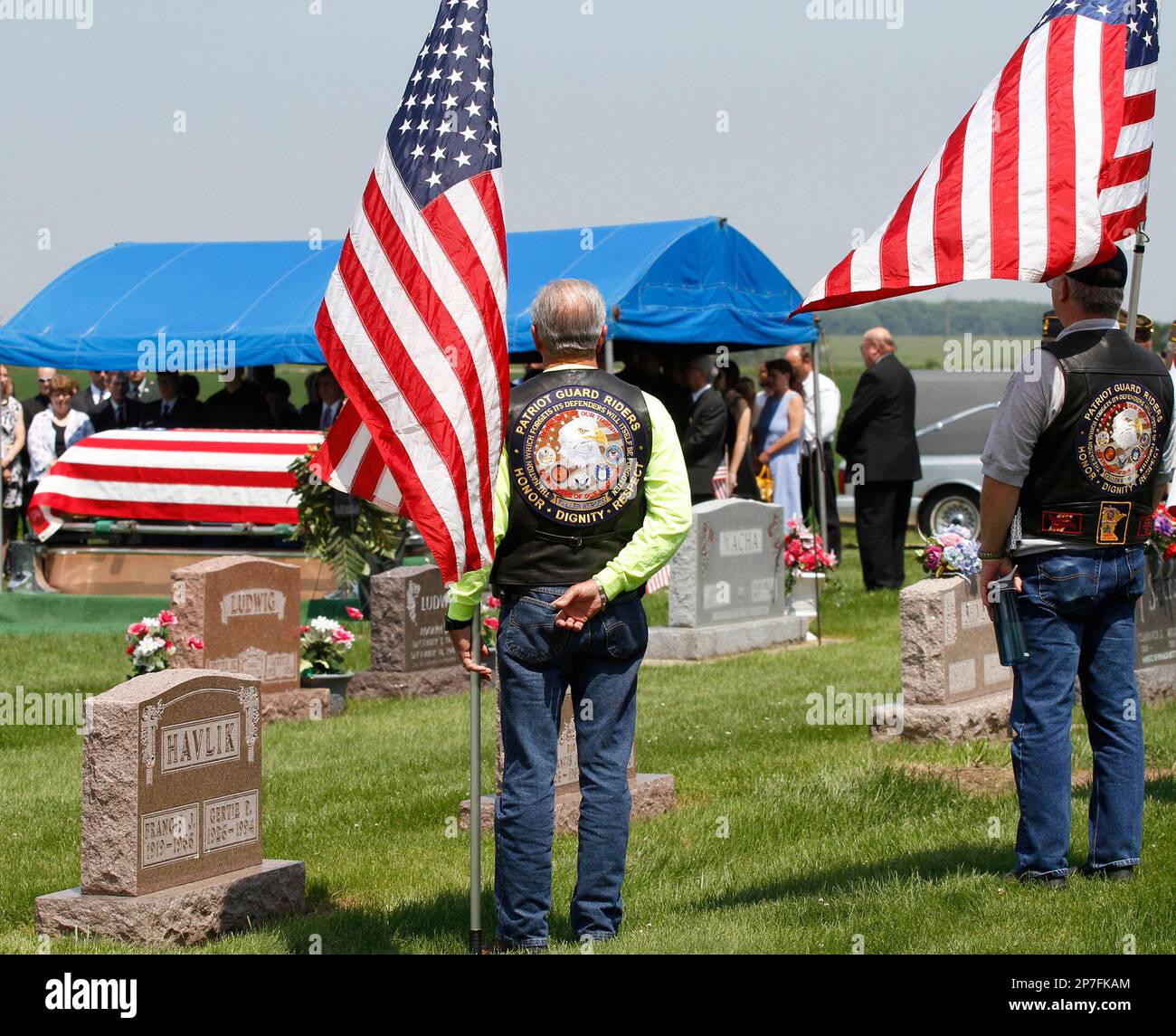 Patriot Guard Riders stand guard during the burial service of Spc