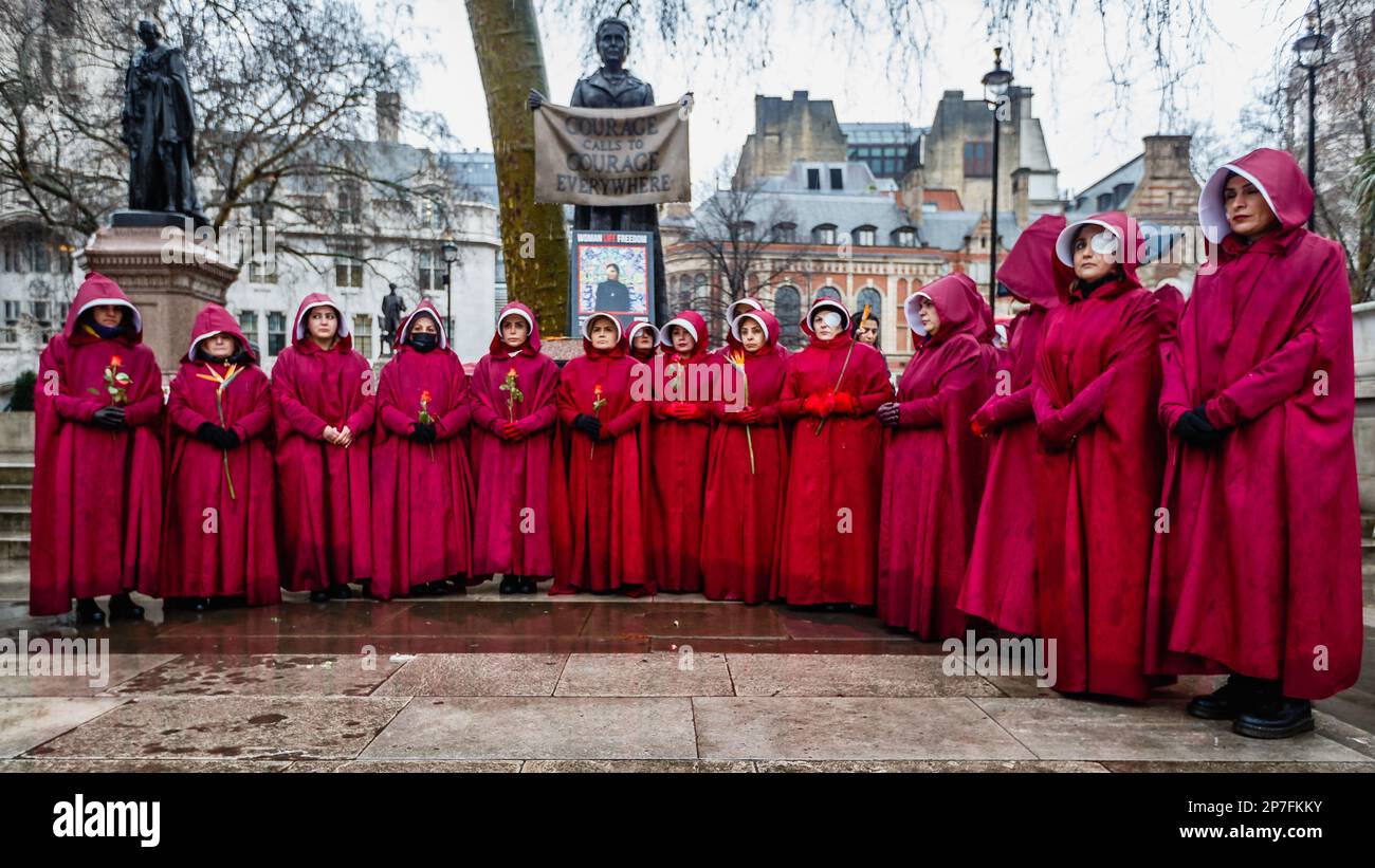 British-Iranian women protesters dressed like characters from The Handmaid's Tale in Parliament Square on International Women's Day 2023. Stock Photo