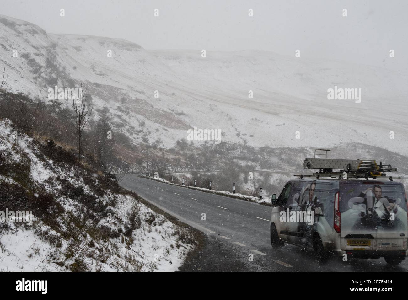 Storey Arms, Brecon Beacons, South Wales, UK.  8 March 2023.  UK weather: Traffic passes the A470 with snow covering the area today.  Credit: Andrew Bartlett/Alamy Live News Stock Photo