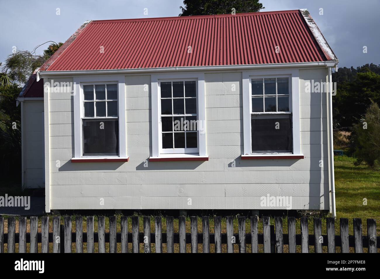 The Old School House, in the middle of Okarito village, was built in 1901 and restored in 1990. It was restored by DOC, the YHA and local community. Stock Photo