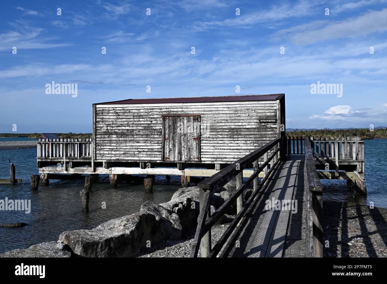 The wharf, jetty and boat house at the West Coast settlement of Okarito. During the 1860s gold rush Okarito saw 500 plus miners disembark in one day. Stock Photo