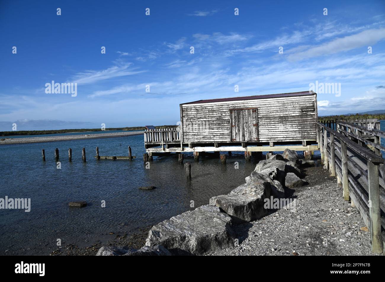 The wharf, jetty and boat house at the West Coast settlement of Okarito. During the 1860s gold rush Okarito saw 500 plus miners disembark in one day. Stock Photo