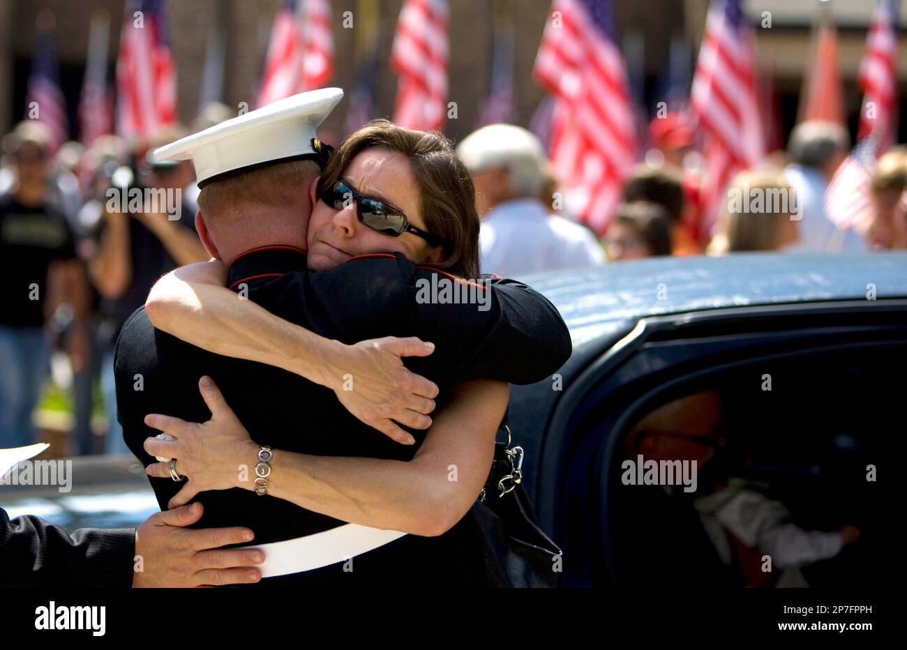 Melissa Whitney, aunt of Sgt. Brandon Bury, hugs Bury's friend and ...