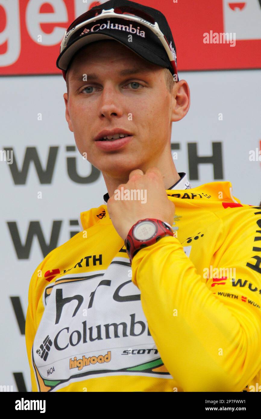 German Tony Martin from Team HTC-Columbia, adjusts the yellow shirt of the  overall leader on the podium after the 4th stage, a 192,2 km race from  Schwarzenburg to Wettingen, at the 74nd