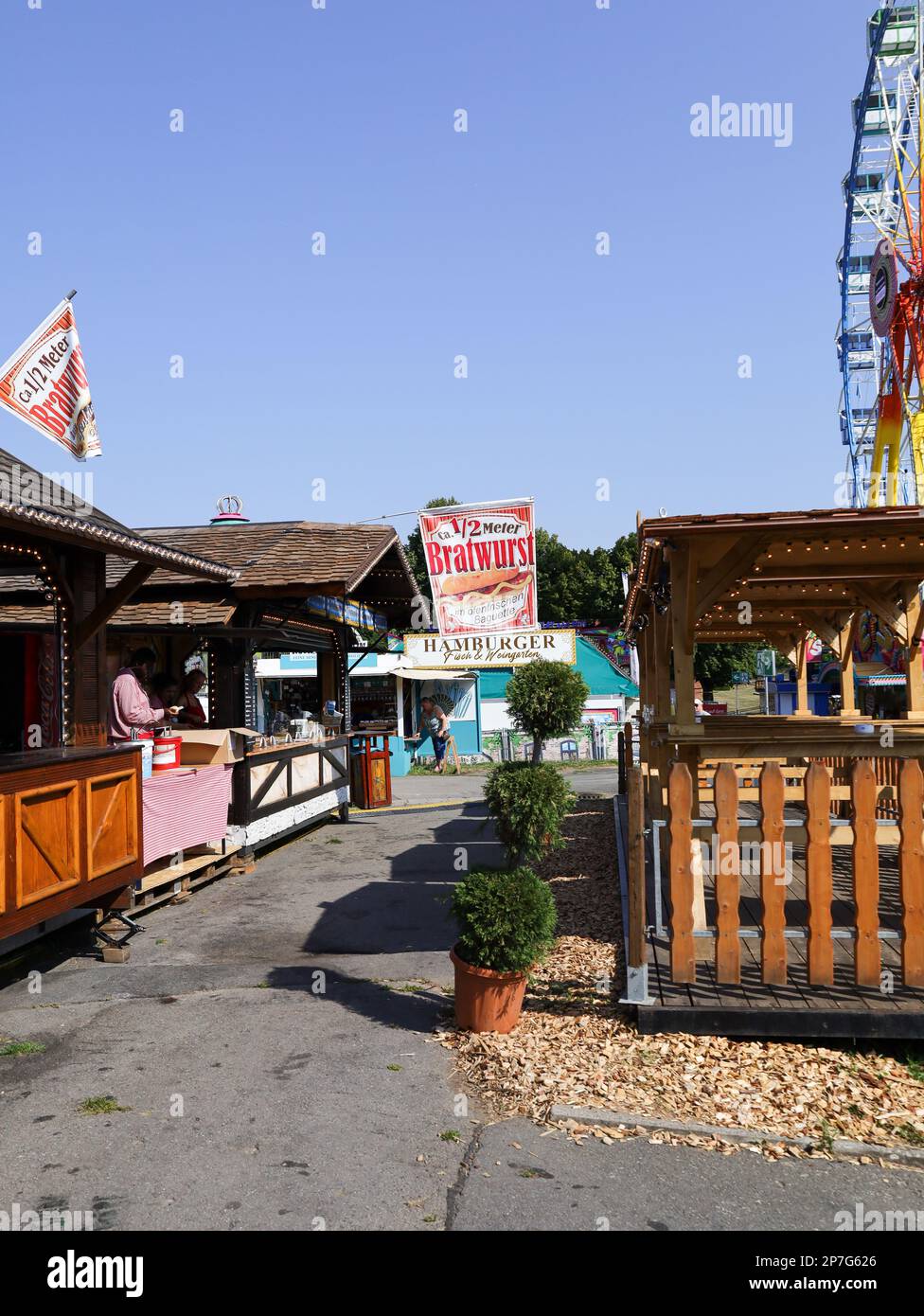 colorful booths and fun rides at a fairground Stock Photo - Alamy