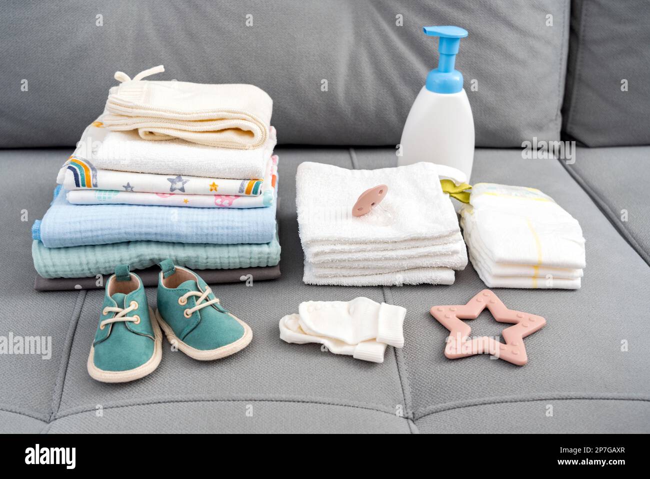 Set of diapers and kids stuff for little baby on a couch. Newborn baby