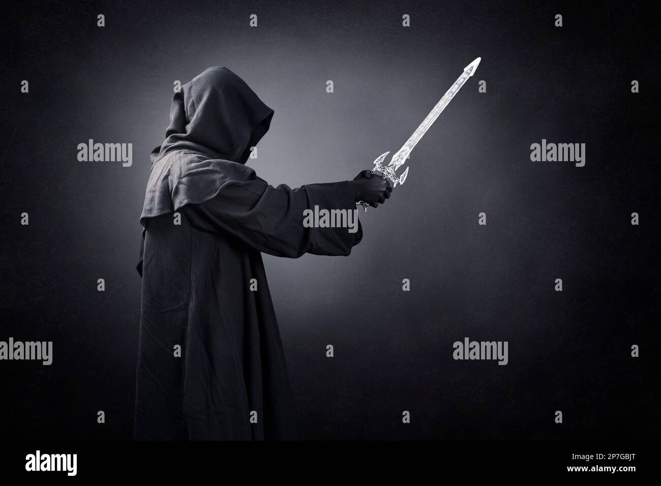 Dark knight with hooded cape and medieval sword over dark misty background Stock Photo