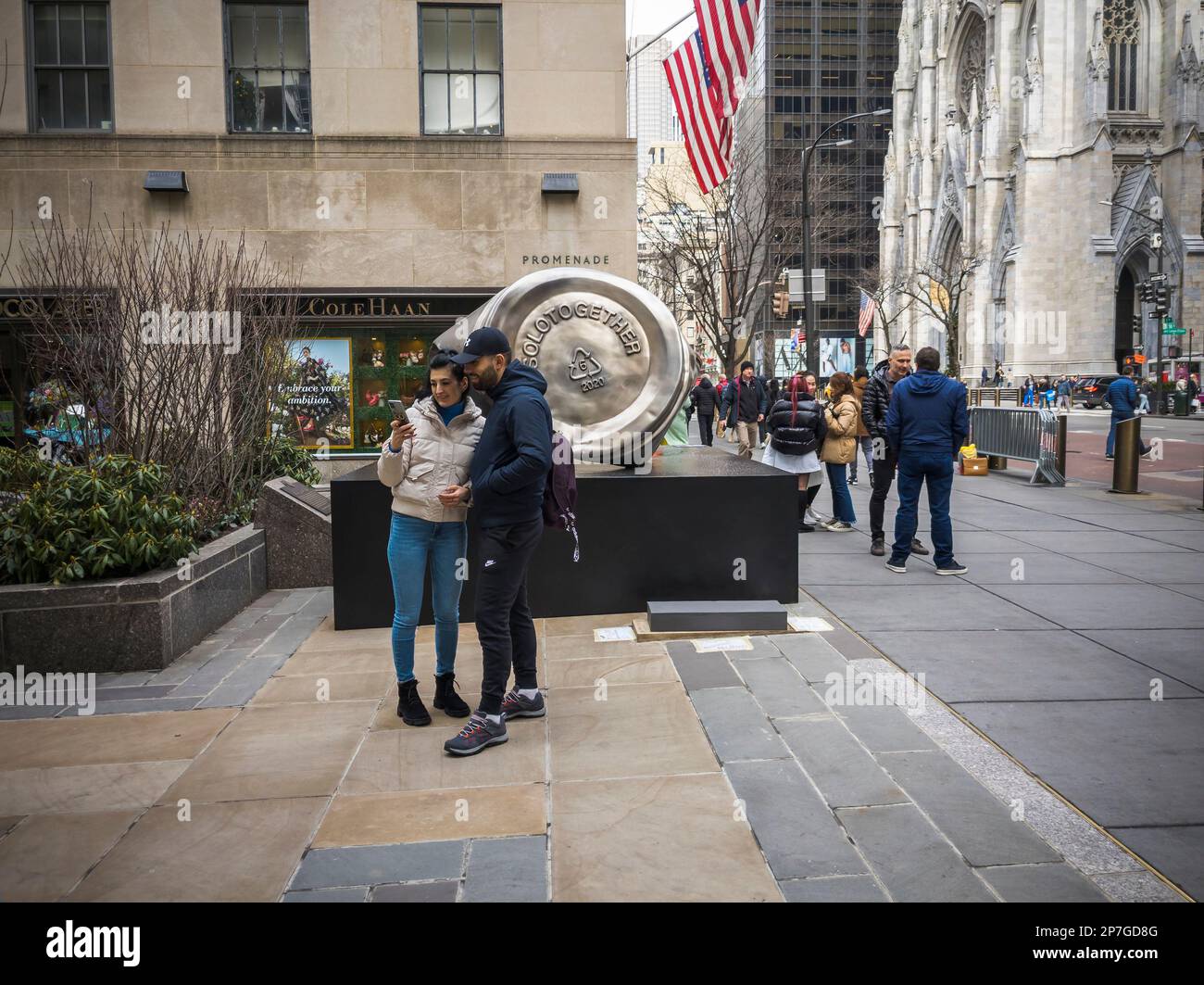 Visitors to Rockefeller Center in New York on Thursday, March 2, 2023 peruse “Resilience” by the artist Paula Crown located on Fifth Avenue at the head of the Channel Gardens.The bronze sculpture in the shape of a crushed Solo brand cup draws attention to the environmental impact of single-use plastics. The display and accompanying show in the Rink Gallery will be on view until May 21.  © Richard B. Levine) Stock Photo
