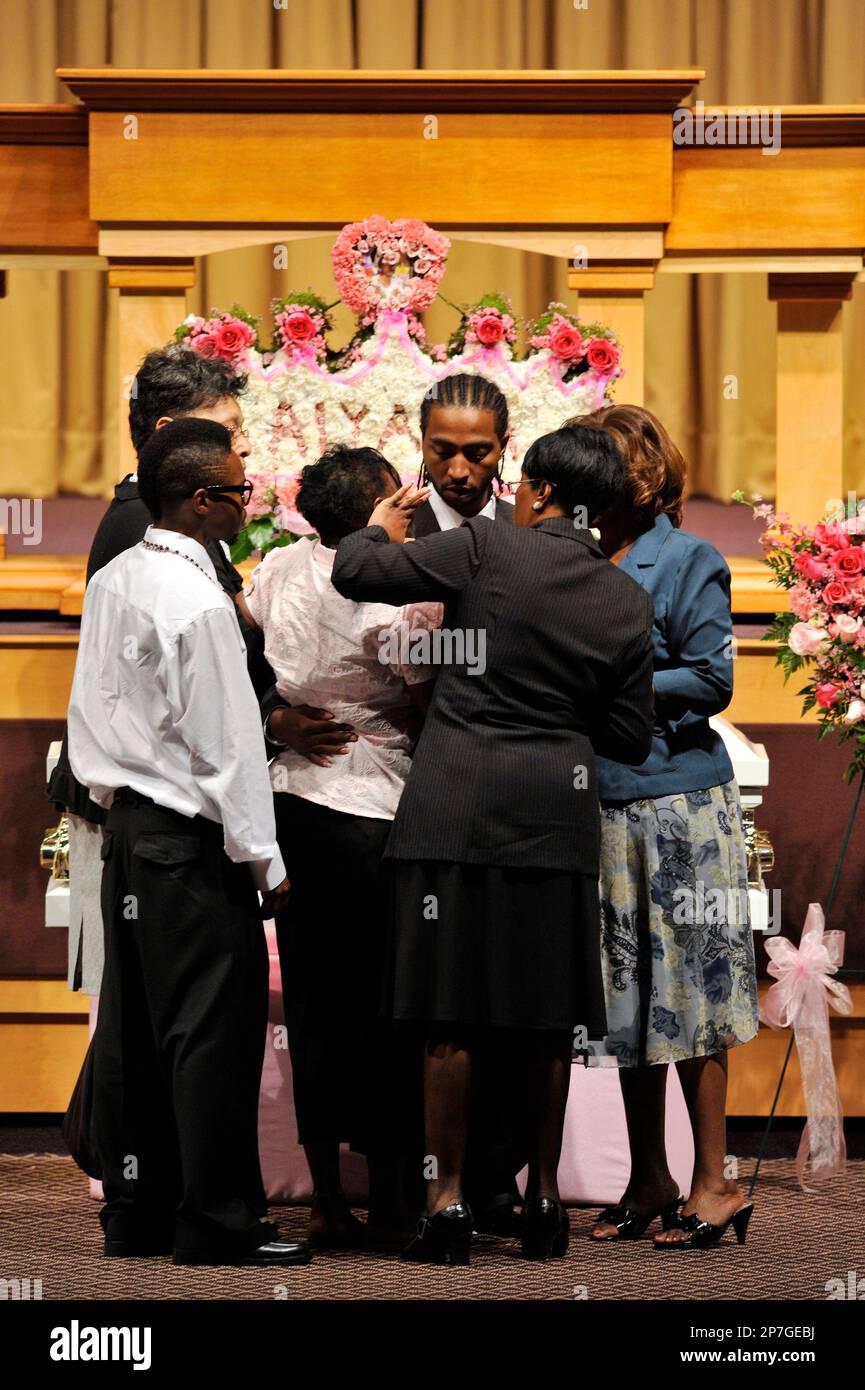 Charles Jones, center, the father of seven-year-old Aiyana Stanley-Jones, is consoled by family and friends as they stand in front of Aiyanas open casket before the funeral service at Second Ebenezer Baptist
