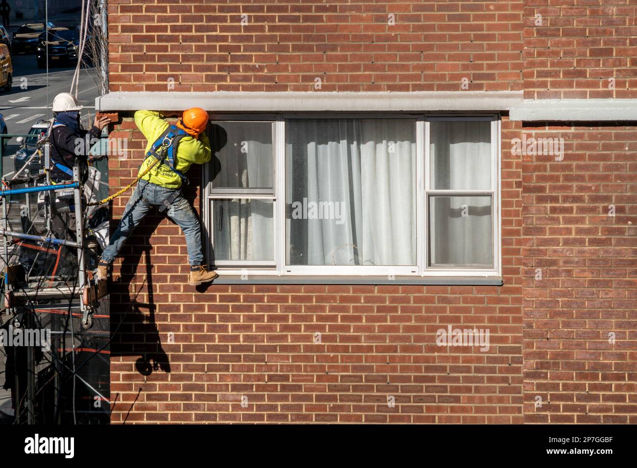 Workers on scaffolding perform city-mandated facade inspection and repair on the exterior of an apartment building in Chelsea in New York on Tuesday, March 7, 2023,  (© Richard B. Levine) Stock Photo