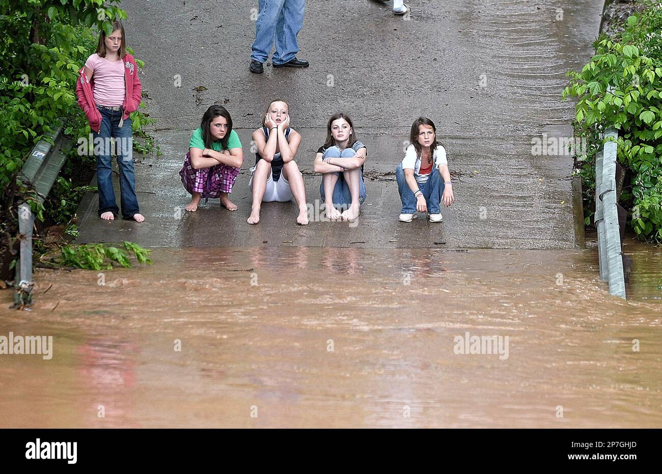 Hannah, Destiny, Katelynn, Katrina and Leslie Boley , left to right, watch as high water passes by image