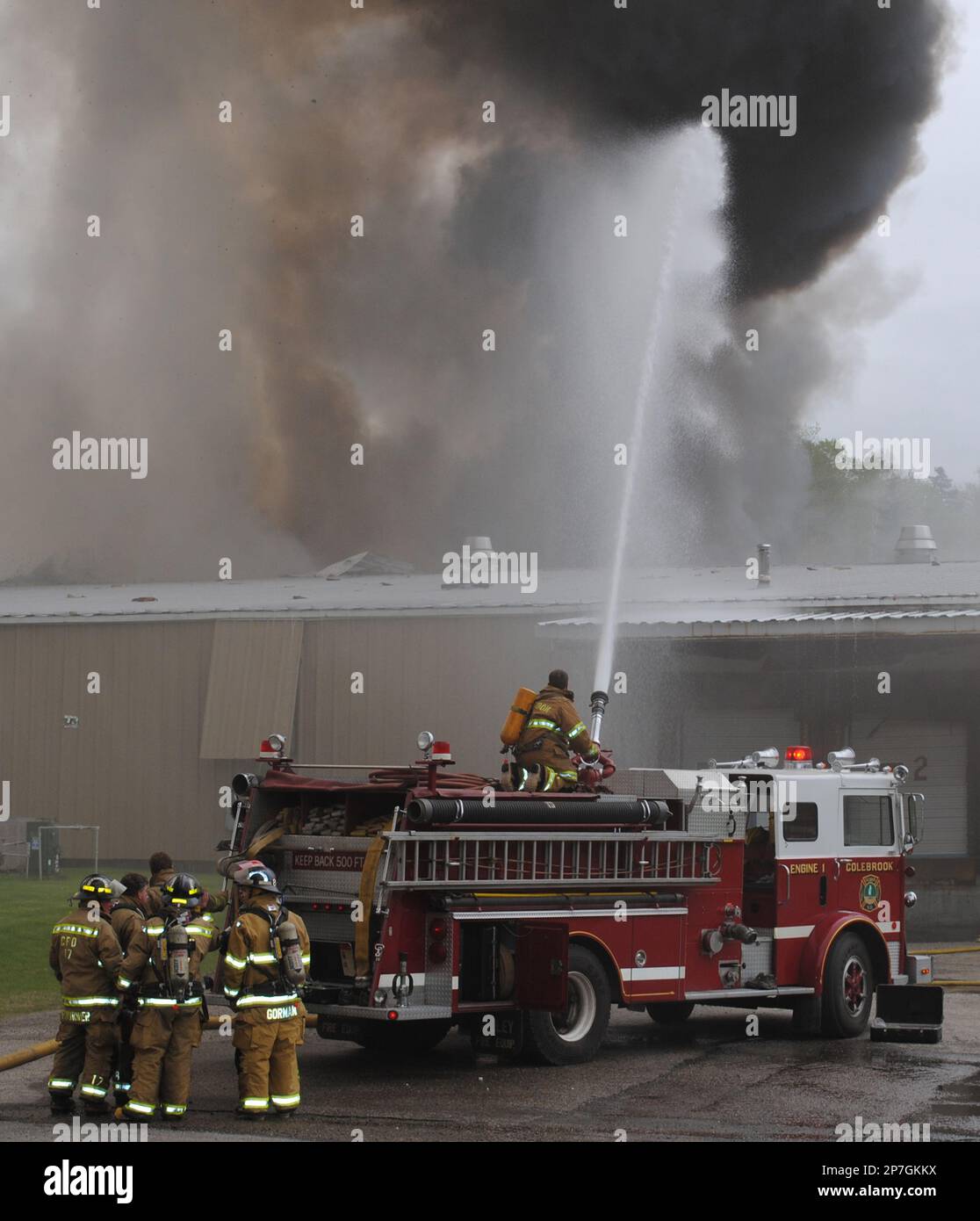Colebrook, N.H., firefighter spray water on a fire at a gun and