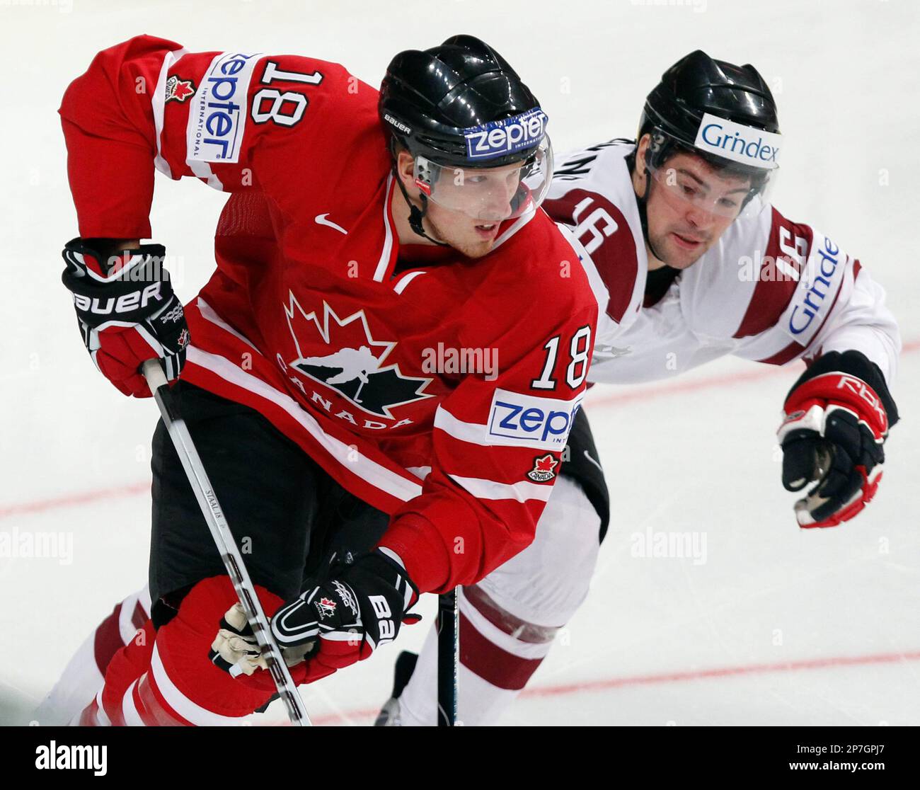 Team Canadas Marc Staal, left, and Latvias Kaspars Daugavins battle for position during first period action at the IIHF world hockey championship in Mannheim, Germany, Monday May 10, 2010