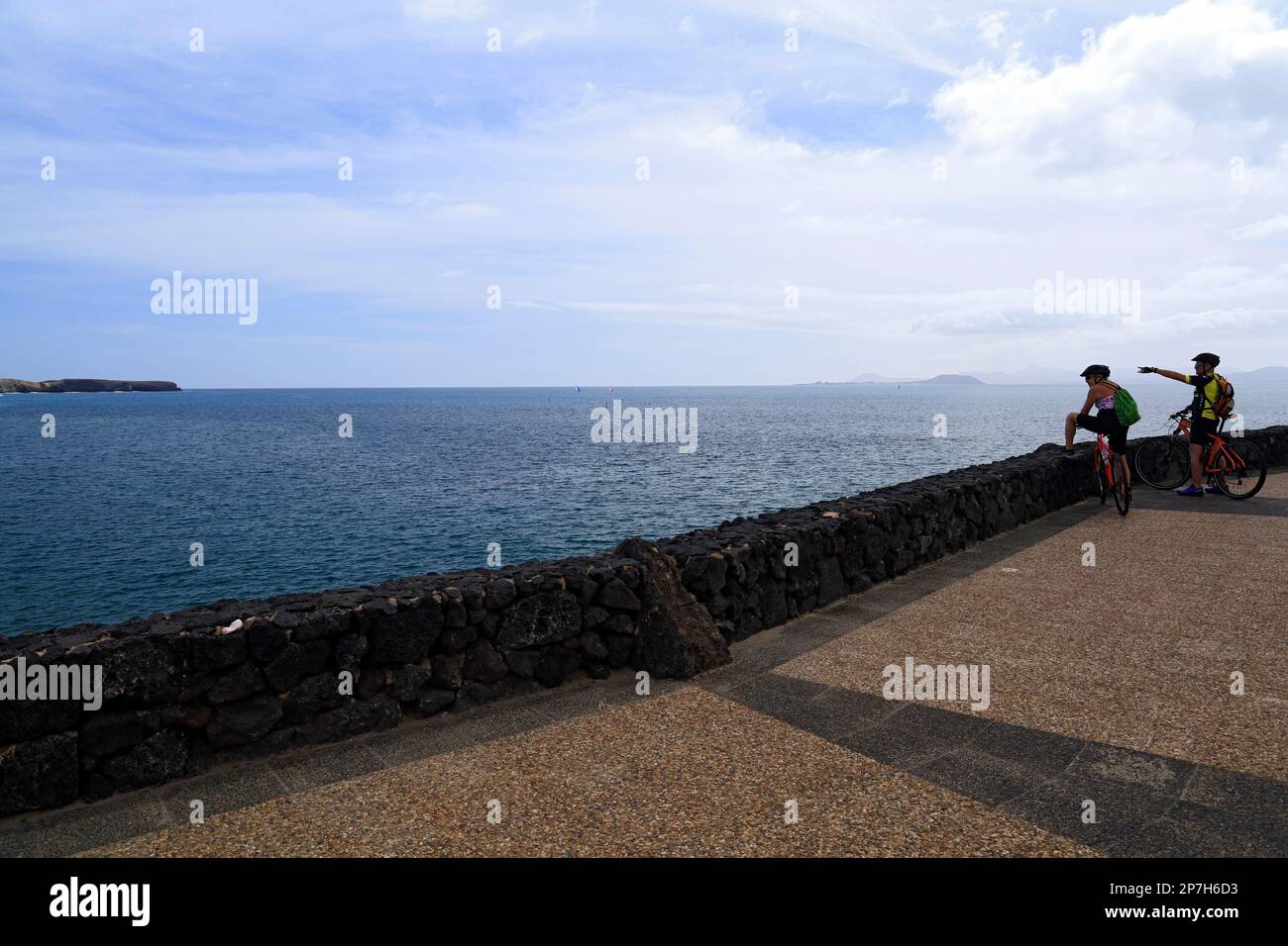Cyclists on Coastal  footpath, Las Coloradas, Playa Blanca, Lanzarote, Canary Islands, Spain. Stock Photo