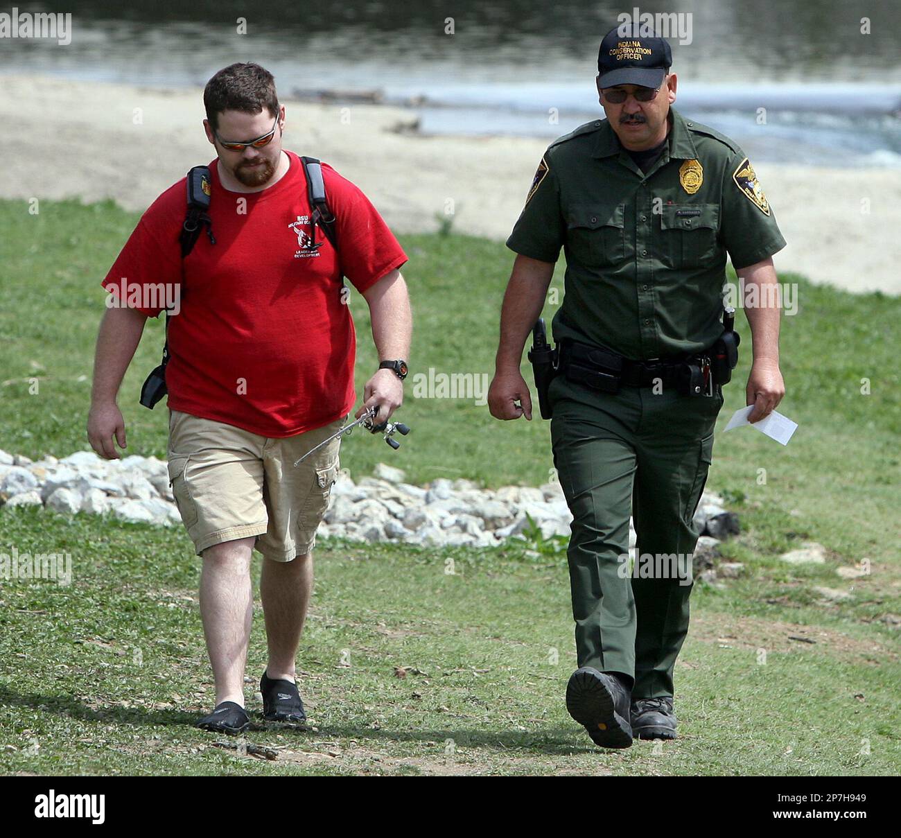 Colin Dudley walks with Indiana conservation officer Rick 