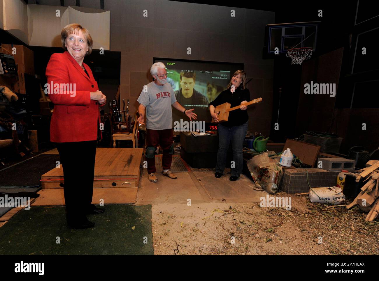 German Chancellor Merkel, left, meets Foley artists John Roesch, center ...