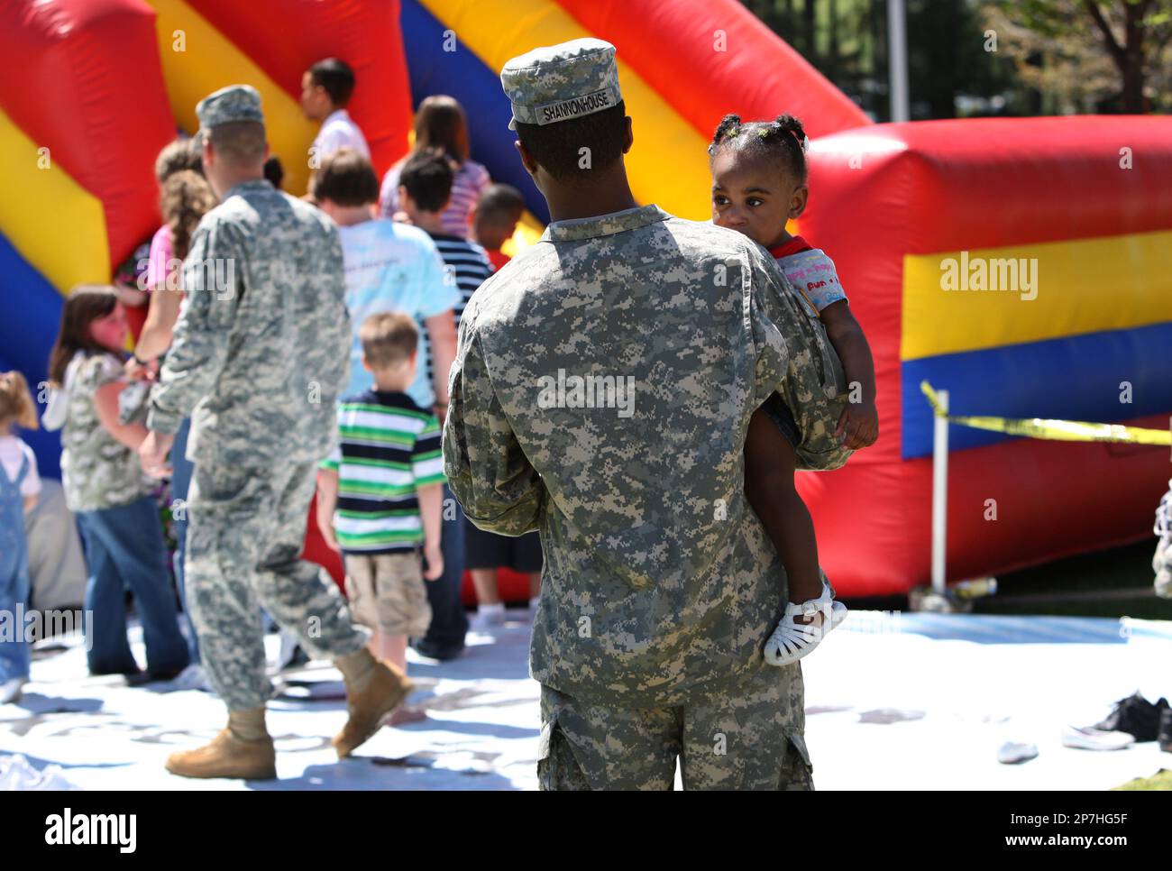 Spc. Fred Shannonhouse of Charlotte holds onto his daughter Jhunyllan ...