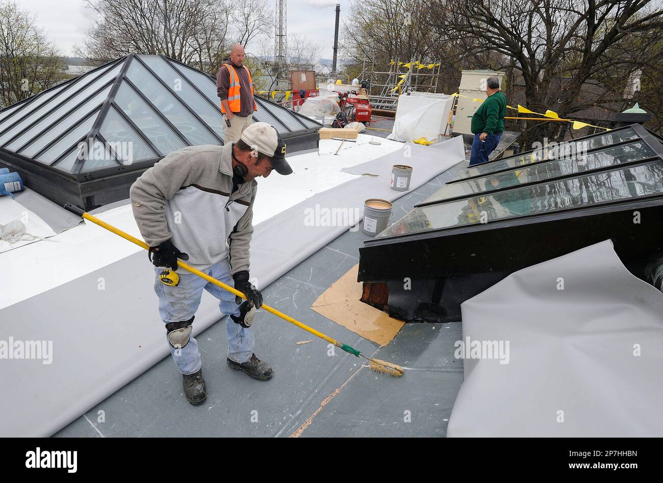 Pvc Reopen Brian Livingston, of Weatherguard Roofing, applies PVC adhesive while ...