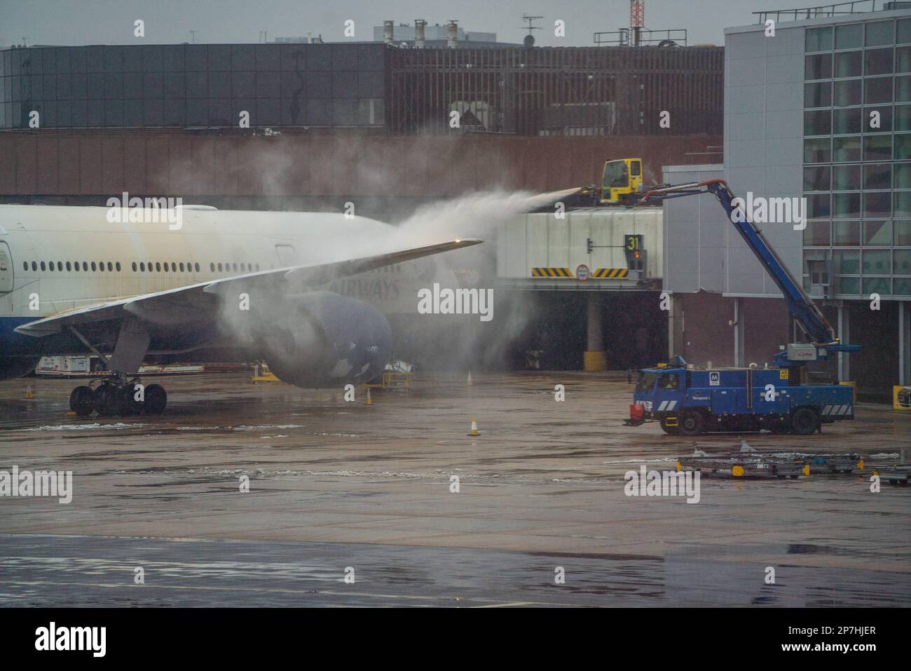 London, UK. 8 March 2023. A British Airways  passenger aircraft  is  sprayed green with De-Icing liquid at Gatwick airport to remove snow and ice . A weather warning has been issued as an Artic blast hits many parts of the UK with freezing temperatures causing travel delays at airports.  Credit: amer ghazzal/Alamy Live News. Credit: amer ghazzal/Alamy Live News Stock Photo
