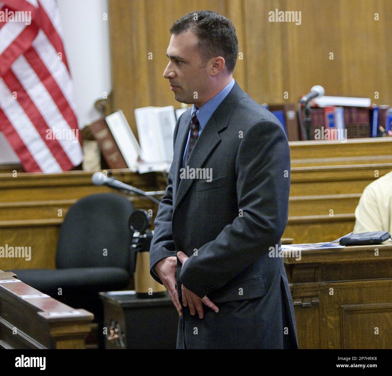 Seattle Police Officer Benjamin L. Kelly shows the jury how Maurice  Clemmons reached for his midsection during their encounter in his testimony  during a fact-finding hearing that will determine whether the shooting
