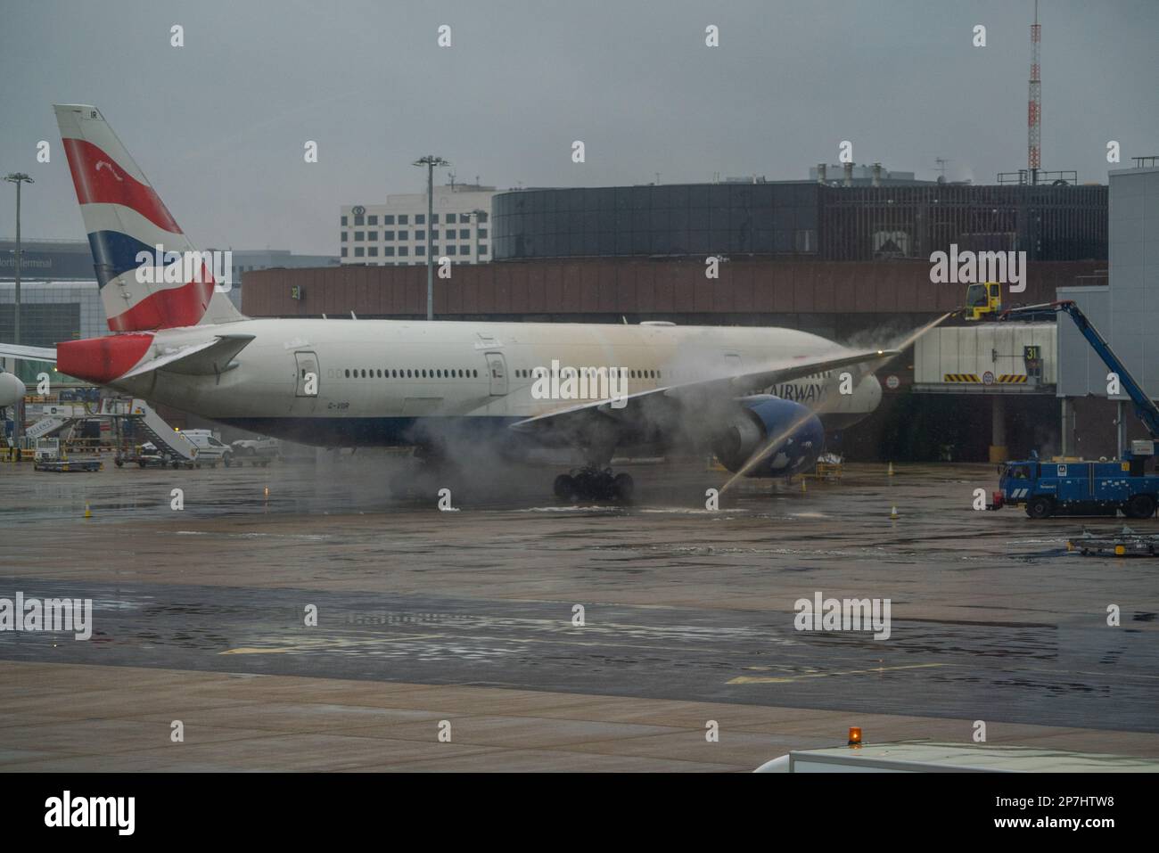 London, UK. 8 March 2023. A British Airways  passenger aircraft  is  sprayed green with De-Icing liquid at Gatwick airport to remove snow and ice . A weather warning has been issued as an Artic blast hits many parts of the UK with freezing temperatures causing travel delays at airports.  Credit: amer ghazzal/Alamy Live News. Credit: amer ghazzal/Alamy Live News Stock Photo