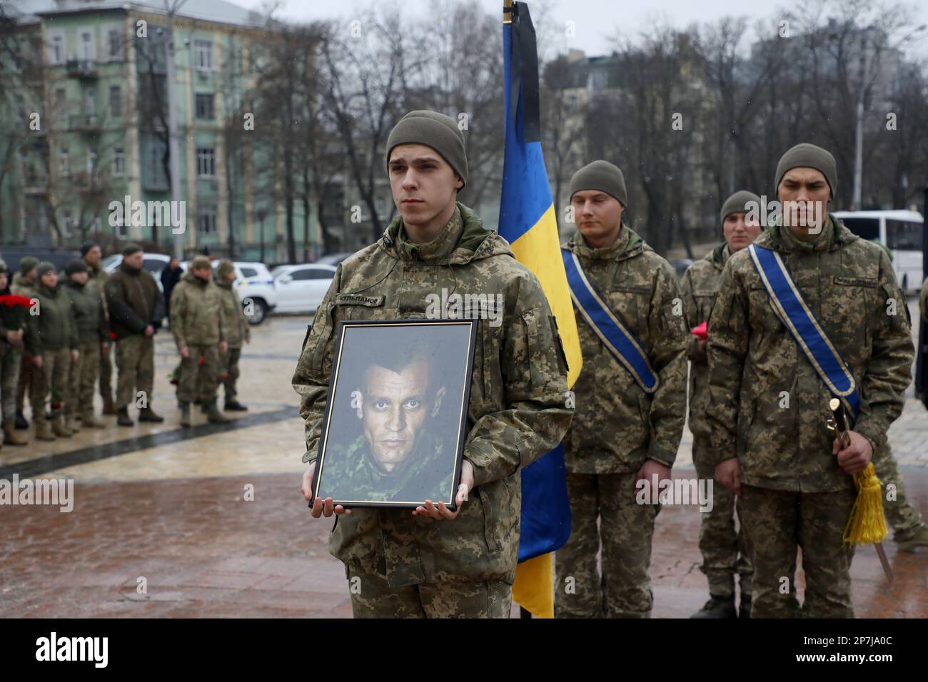 KYIV, UKRAINE - MARCH 8, 2023 - Servicemen hold the portrait of ...