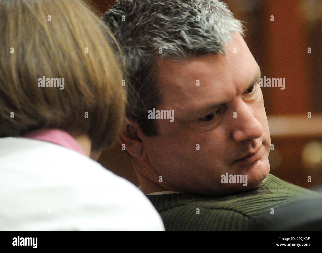 Confessed killer Kevin Wayne Dunlap leans over to listen to a comment