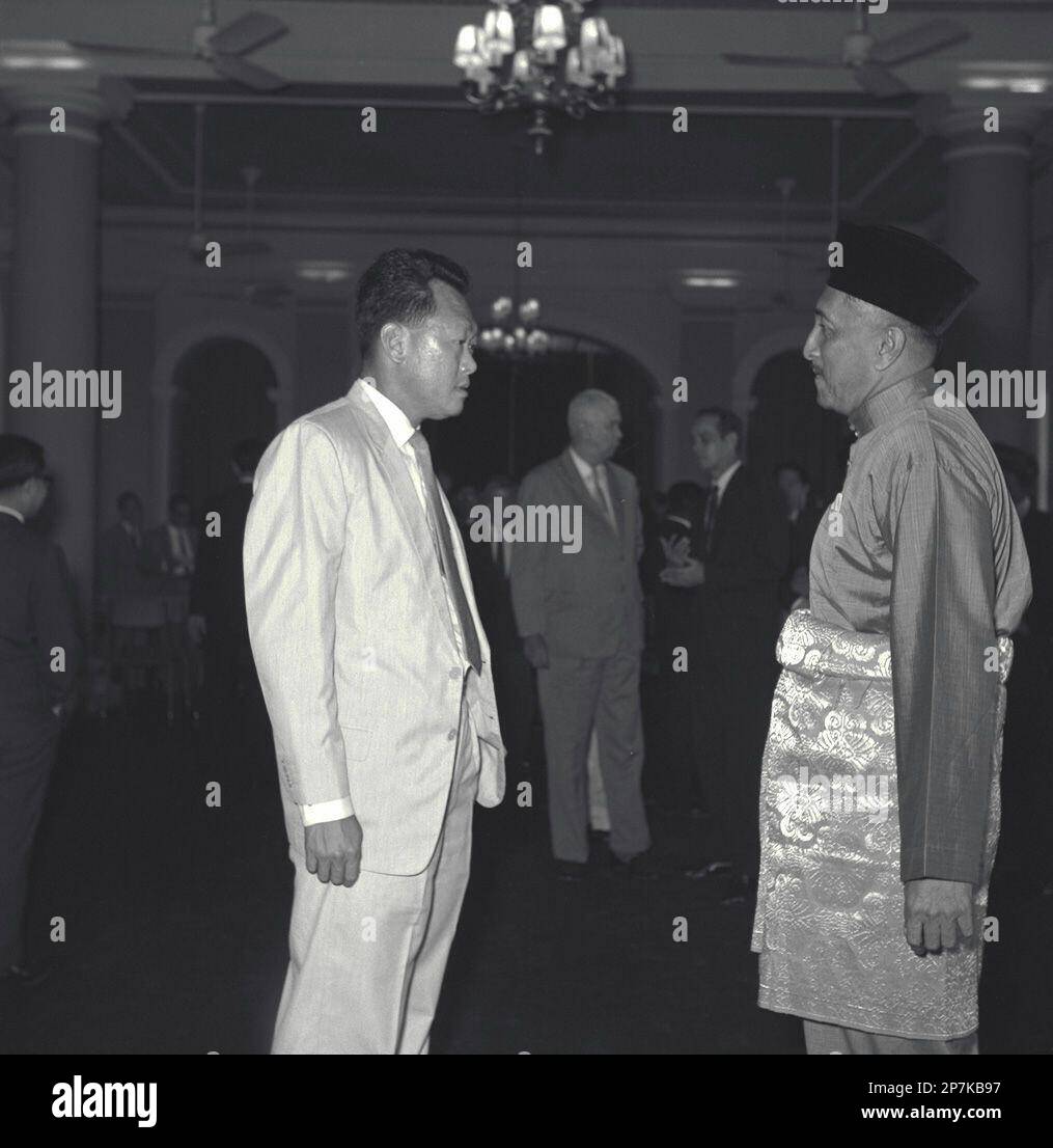 Prime Minister Mr Lee Kuan Yew (left) speaking to the new Singapore Head of  State, Tun Yusof bin Ishak who was sworn in for a new five-year term of  office. (Singapore Press