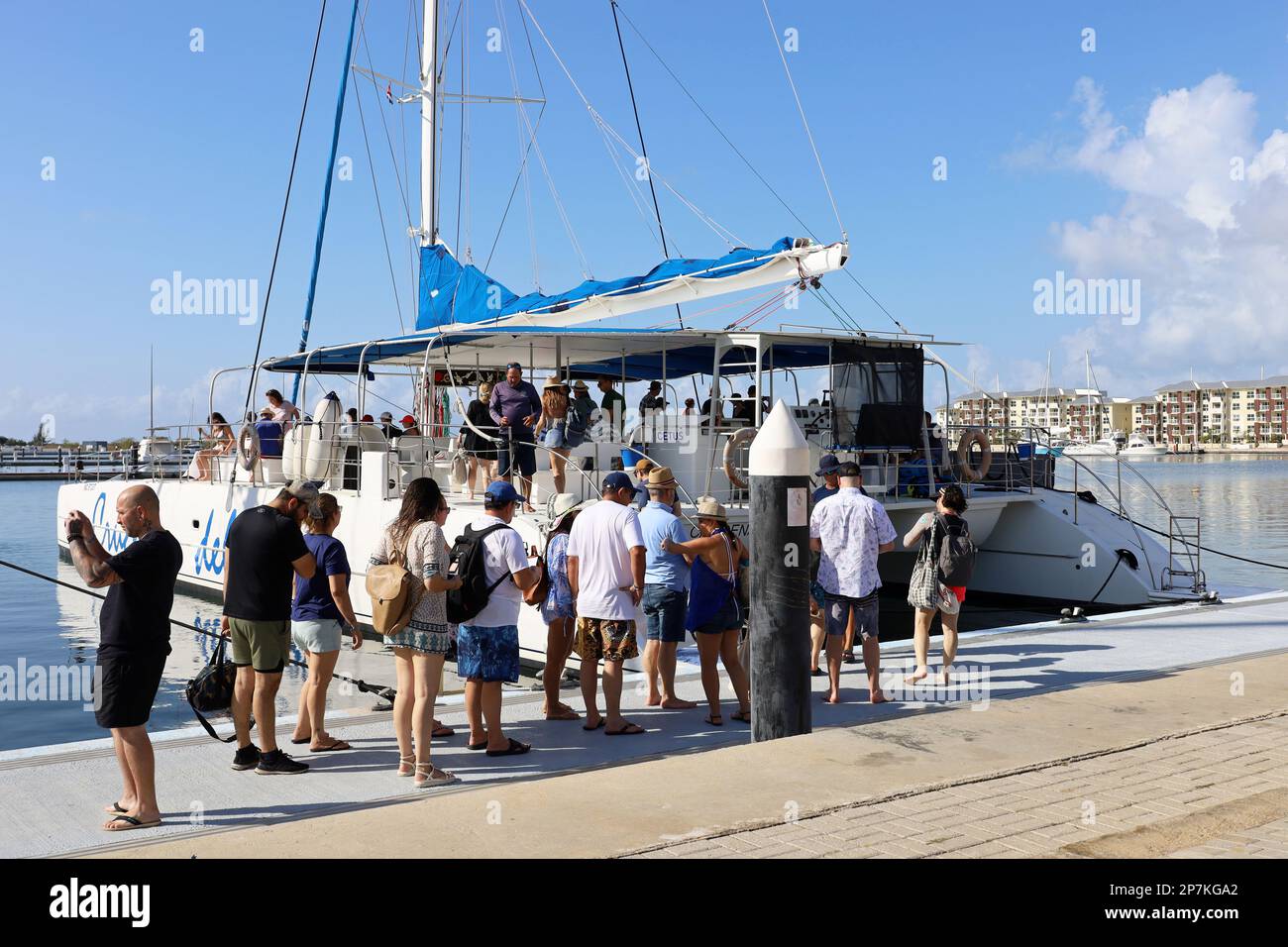 Tourists on marina during boarding the sail catamaran boat, Atlantic