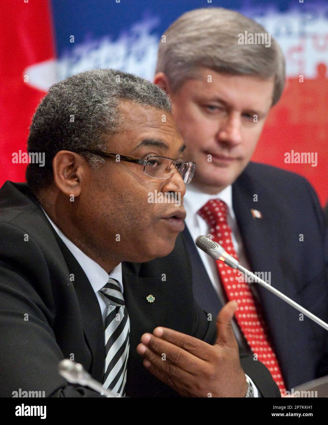 Prime Minister Stephen Harper, right, listens to Haitian Prime Minister Jean-Max  Bellerive address a conference looking at the future of Haiti Monday  January 25, 2010 in Montreal. (AP Photo/The Canadian Press, Paul