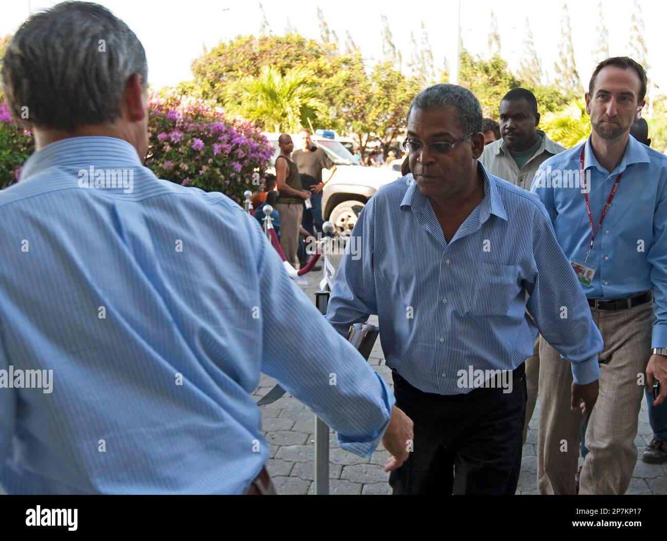 Canadian Ambassador Gilles Rivard, left, greets Haitian Prime Minister