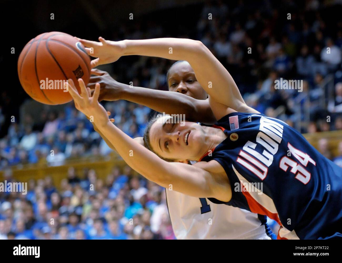 Connecticut's Kelly Faris (34) reaches for a loose ball over Duke's