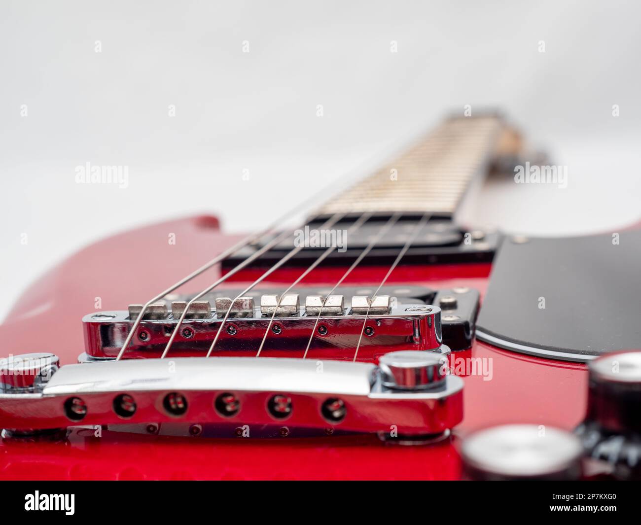 Red electric guitar isolated on white background. Musical instrument guitar. Close-up. Stock Photo