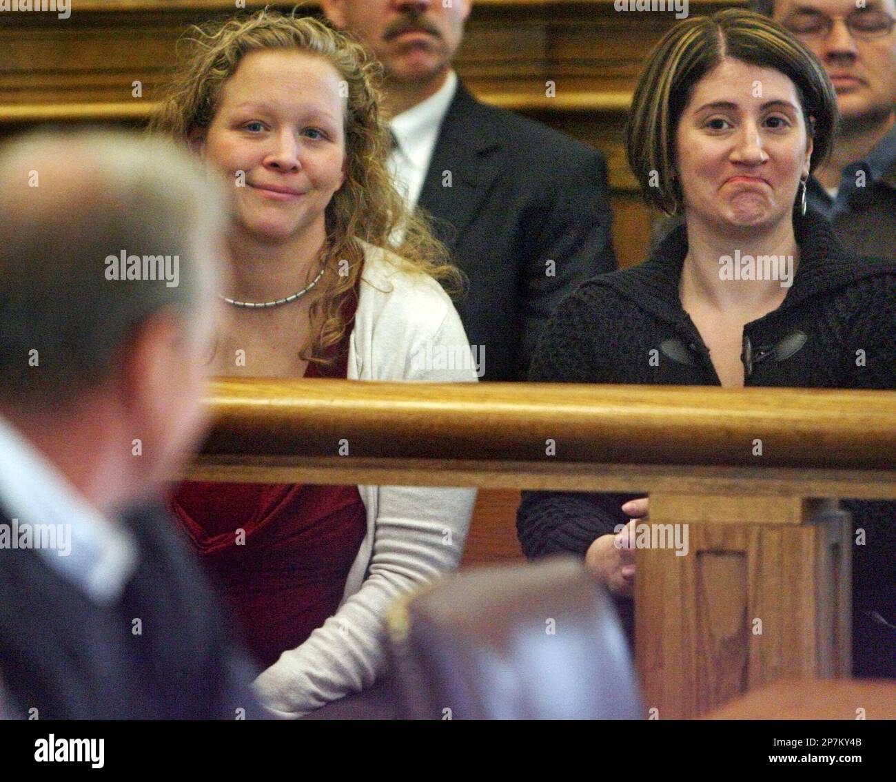 Britt Greineder Cavalletto, left rear, and another woman who would not give  her name, right, smile at Dirk Greineder, left foreground, in Norfolk  Superior Court in Dedham, Mass., Thursday, Jan. 14, 2010.