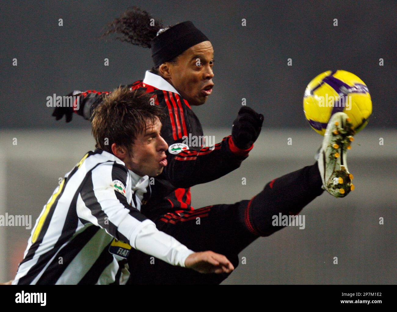 AC Milan's Brazilian forward Ronaldinho, background, controls the ball as  Juventus' defender Zdenek Grygera, of Czech Republic, vies for the ball,  during their Serie A soccer match, at the Olympic stadium in