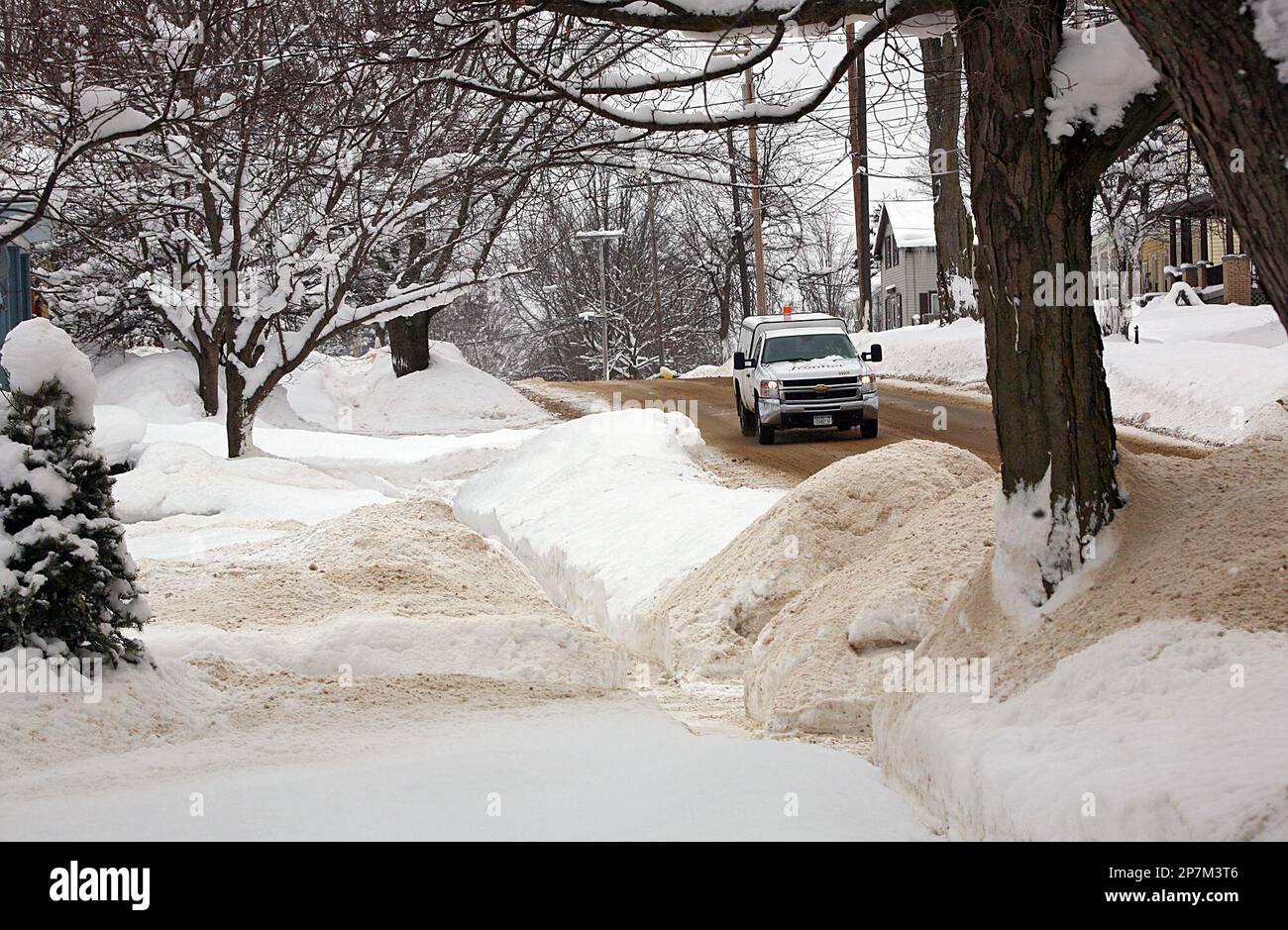 Snow is piled up along the sidewalks and street in Pulaski, N.Y