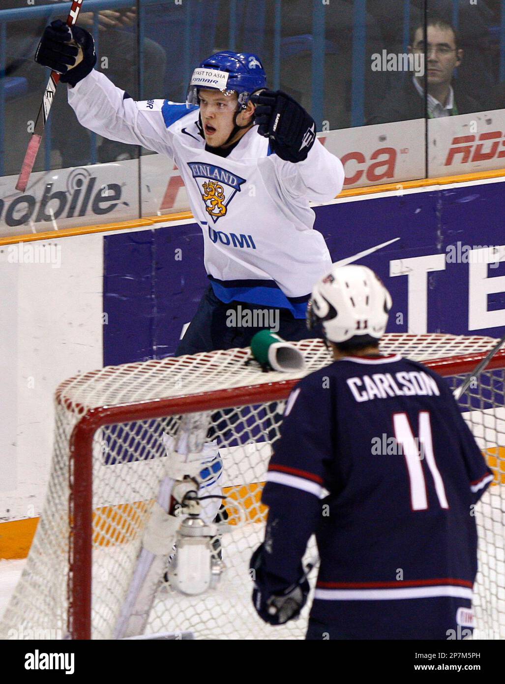 Team Finland's Eero Elo celebrates his goal as Team USA's John Carlson (11)  watches during the second period of a quarter final hockey game at the  world junior hockey championship on Saturday,