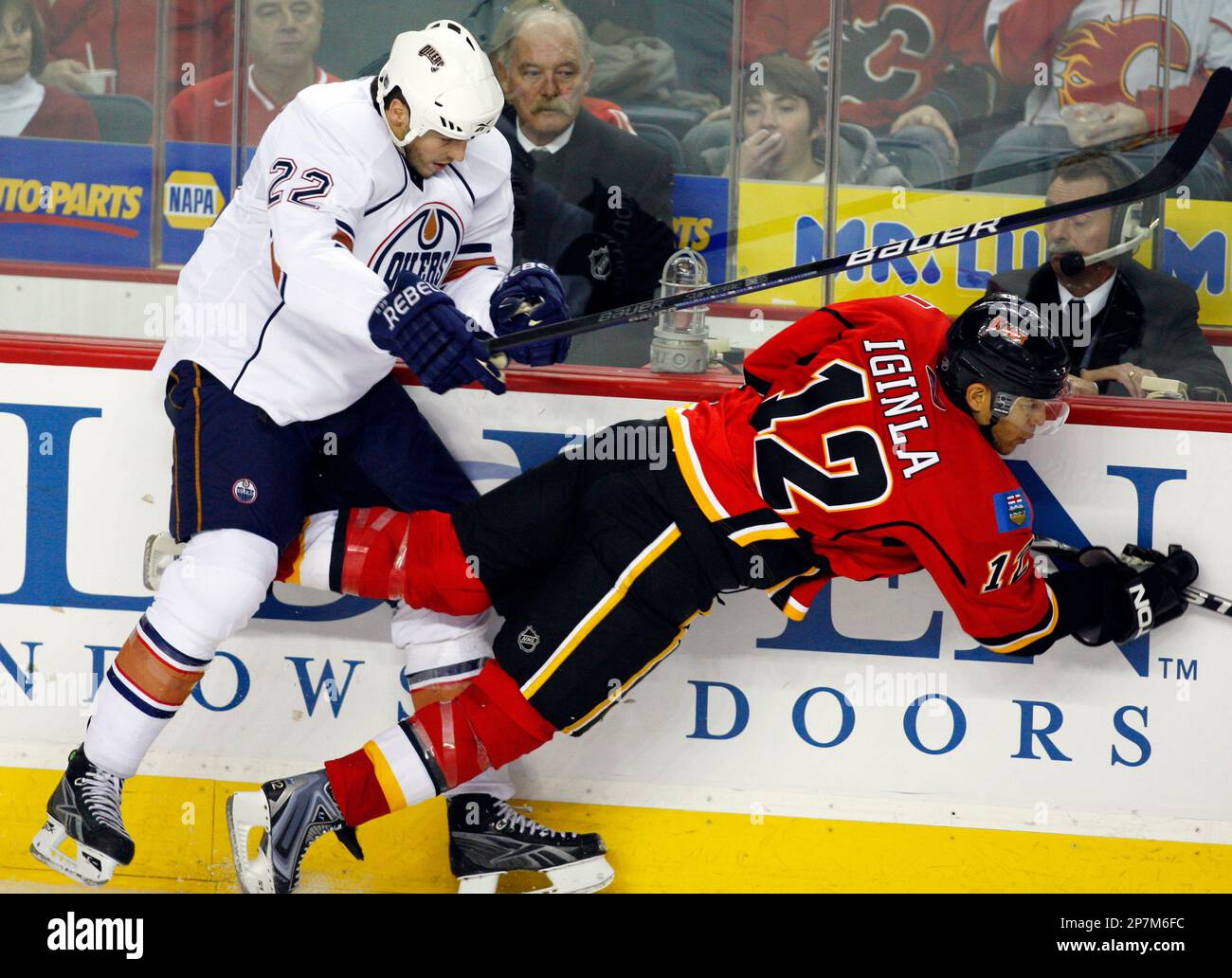 Edmonton Oilers' Jean-Francois Jacques, left, checks Calgary Flames ...