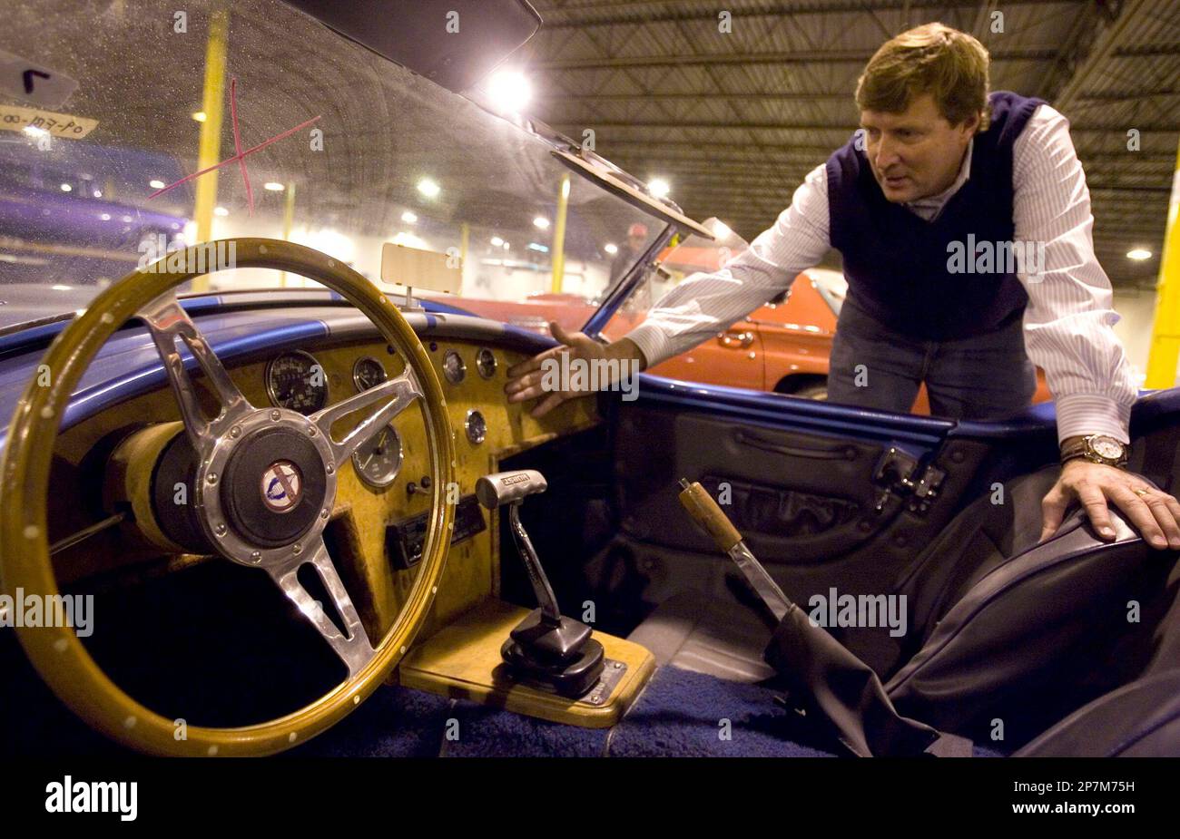 This Dec. 29, 2009 photo shows auctioneer Rob Olson looking over a Shelby  Cobra at a warehouse in Salt Lake City. Erkelens & Olson Auctioneers are  selling nearly 200 muscle, luxury, classic