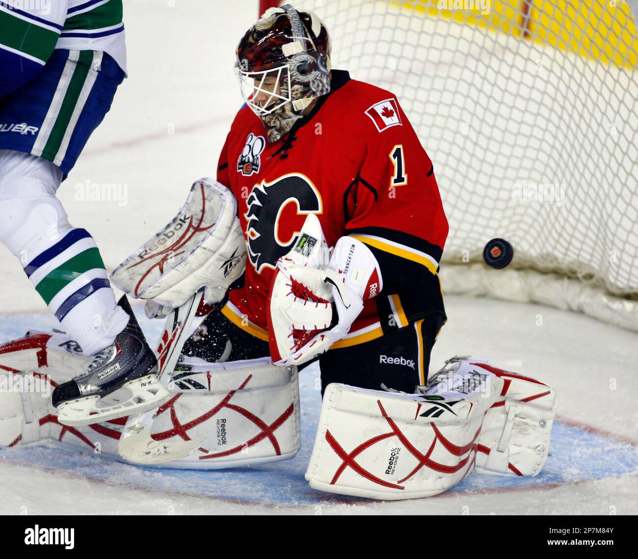 Calgary Flames goalie Curtis McElhinney (1) loses track of the puck on