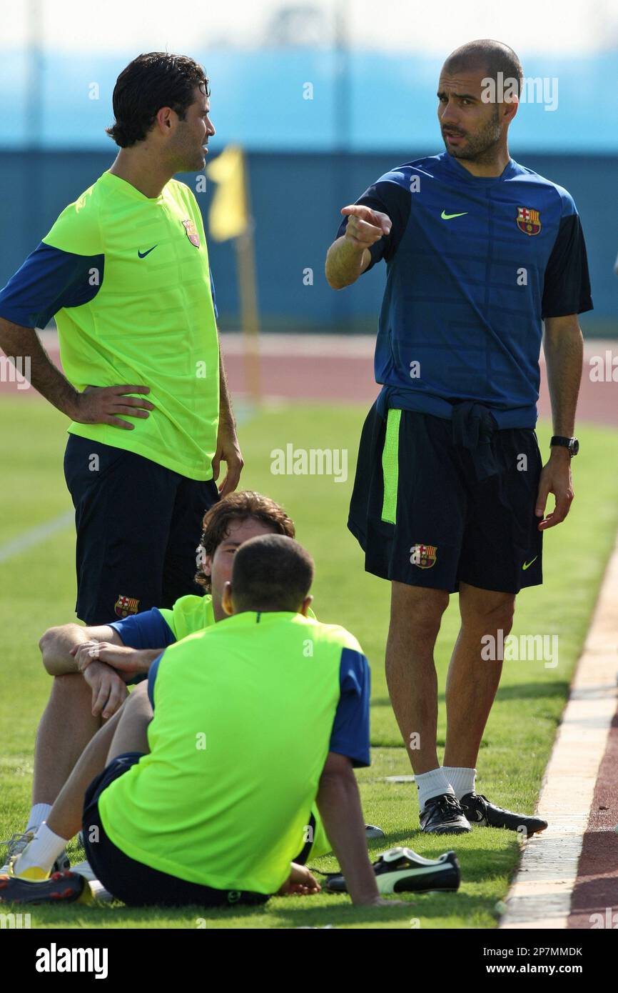 FC Barcelona's coach Pep Guardiola, right, speaks with Rafael Marquez, from  Mexico, after a training session in Abu Dhabi, United Arab Emirates,  Monday, Dec. 14, 2009. FC Barcelona will play against Atlante