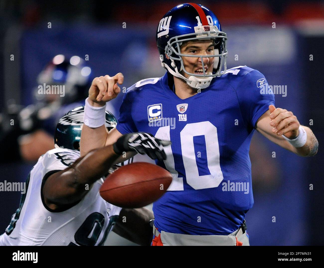 Philadelphia Eagles defensive end Darren Howard (90) hits Dallas Cowboys  quarterback Tony Romo (9) as throws the ball in first half action in the NFL  - NFC Playoffs football game between the