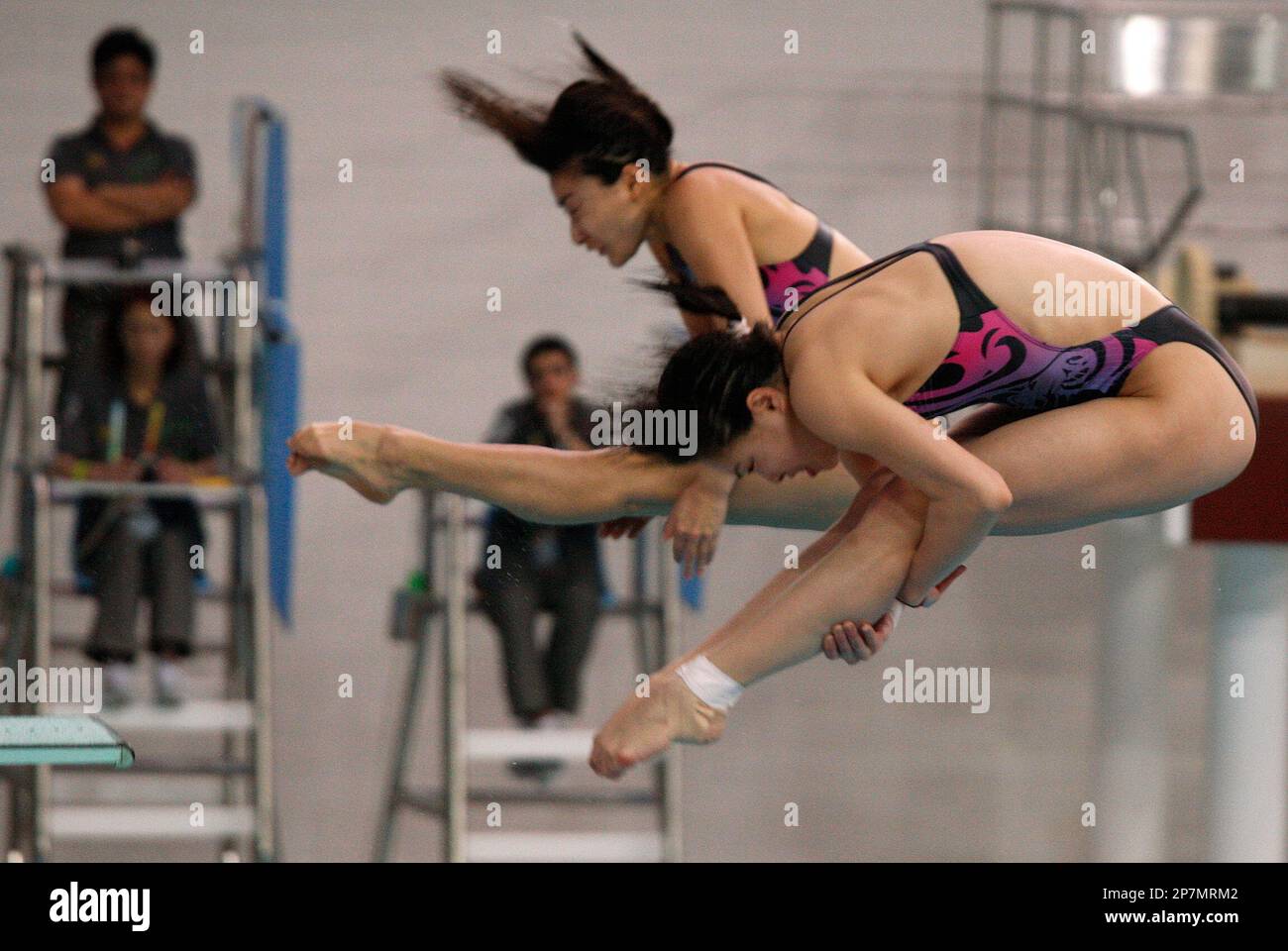Guo Jingjing and Wu Minxia, right, of China compete in the womens 3-meter  synchronized springboard diving final in Hong Kong East Asian Games Sunday,  Dec. 13, 2009. Guo and Wu won the