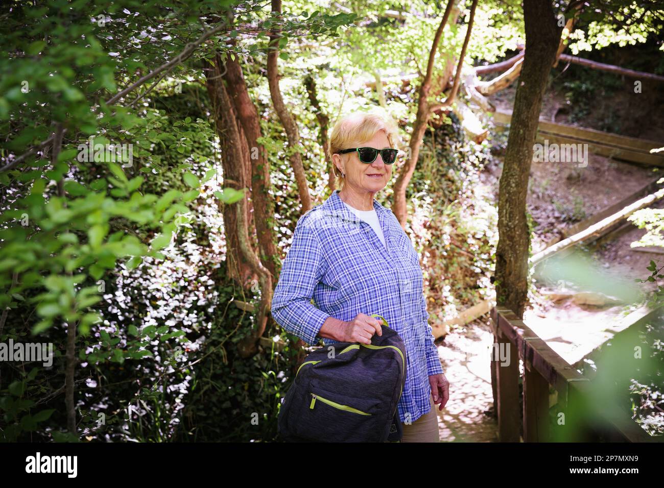 Smiling senior woman backpack hi-res stock photography and images - Alamy