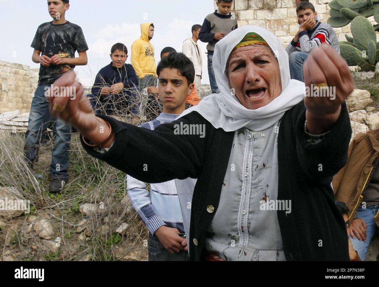 A Palestinian woman reacts after a mosque was vandalized in the West