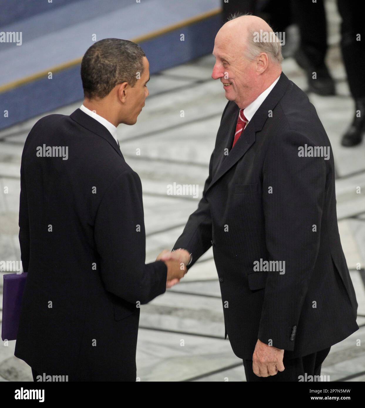 President and Nobel Peace Prize laureate Barack Obama, left, greets