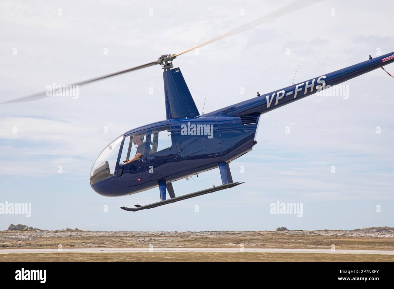 A Robinson R-44 Raven II helicopter, registration number VP-FHS, taking off from Stanley Airport in The Falkland Islands. Stock Photo