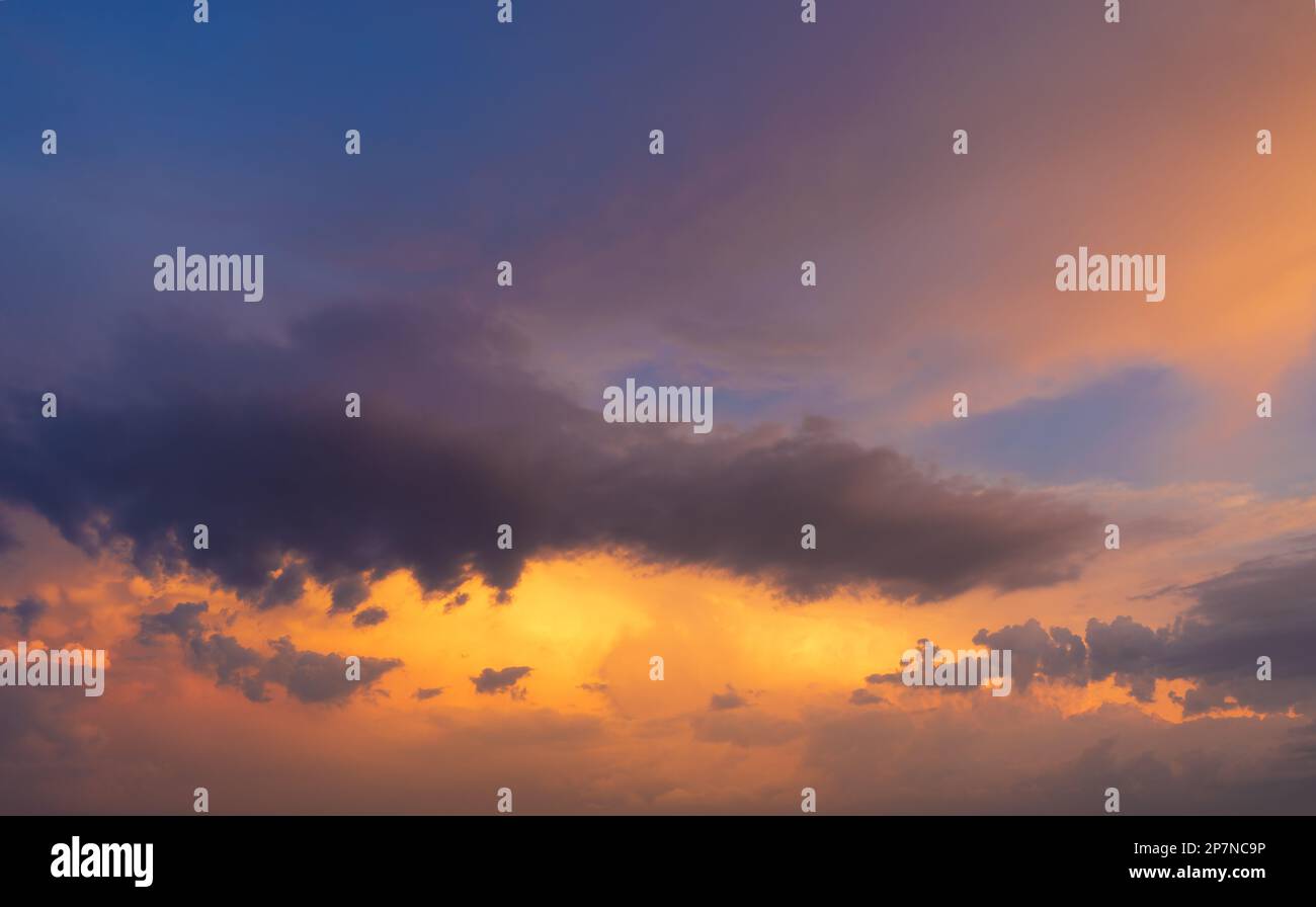 Orange and blue colored dramatic sunset sky Stock Photo - Alamy