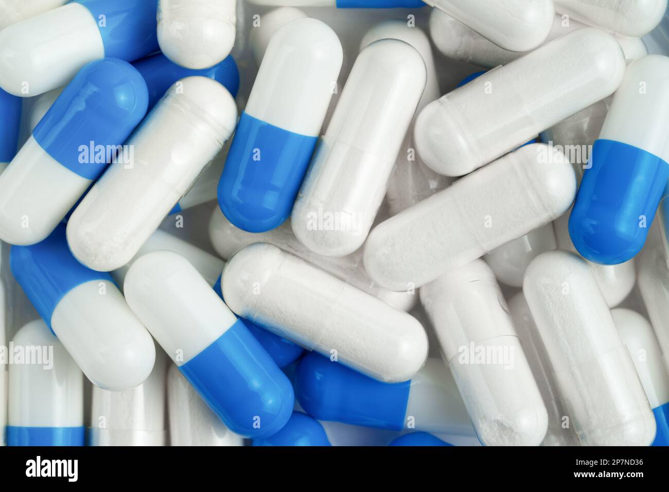 White and blue capsules background. Top view Stock Photo Alamy