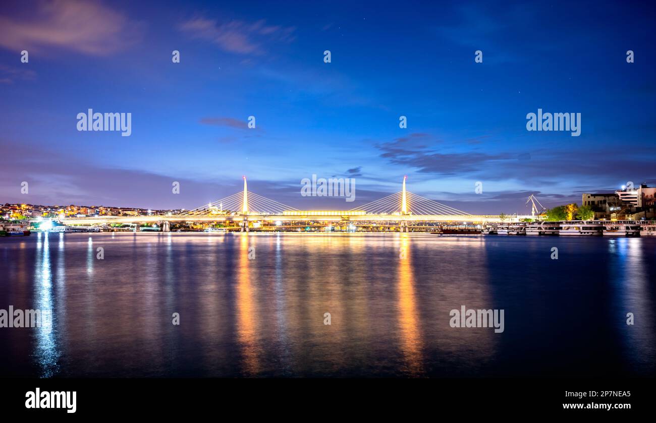 Image of Istanbul Golden Horn Metro Bridge during twilight blue hour ,Turkey Stock Photo